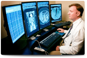 man reviewing monitors of advanced medical imaging